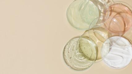 Different skincare products textures and empty Petri dish on beige background. Copy space