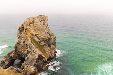 Tall, rugged haystack rocks jut out of the Atlantic ocean along the Portugal coast