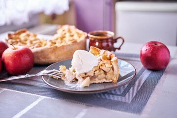 Piece of Fresh homemade Traditional Apple Pie with ice cream on a domestic kitchen