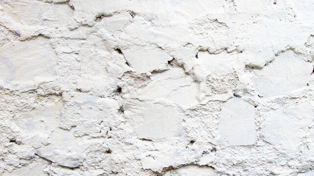 White painted humpy cement plaster wall surface