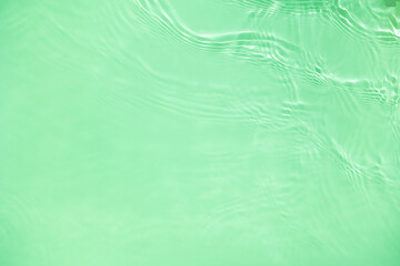 Transparent green clear water surface texture with ripples, splashes. Abstract nature background...