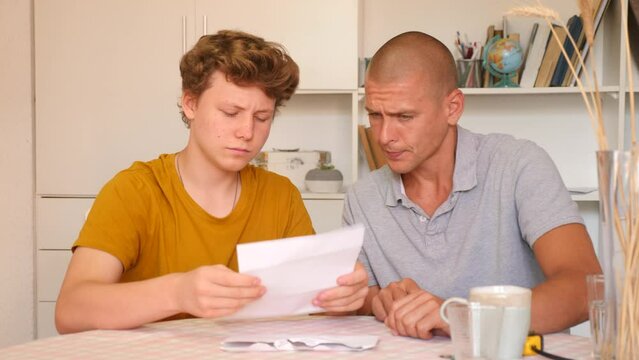 Father and son have recieved letter and reading it. They feeling happy because letter contains good news.