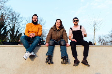 Happy friends hanging out in skate park