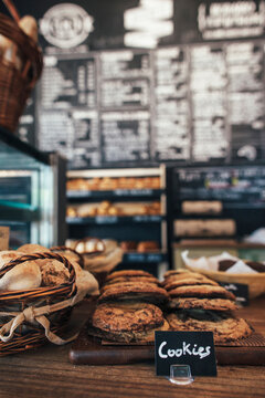 Assortment of cookies and bread on table in bakery