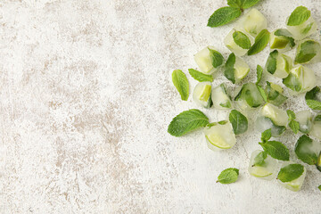 Ice cubes with mint and lime on light background