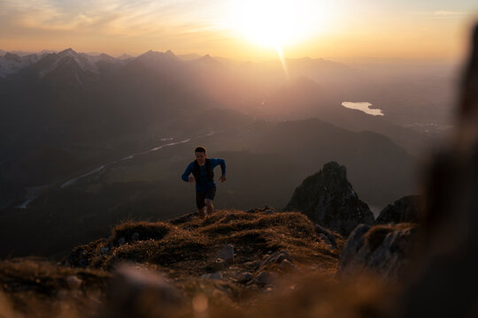 Man hiking on Sauling mountain at sunset