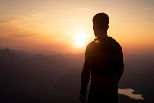 Silhouette man looking at sunset from Sauling mountain