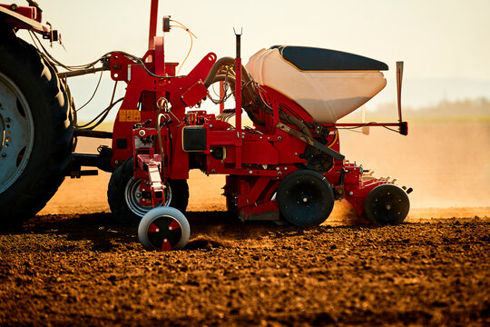 Tractor seeder sowing soybean seeds in field
