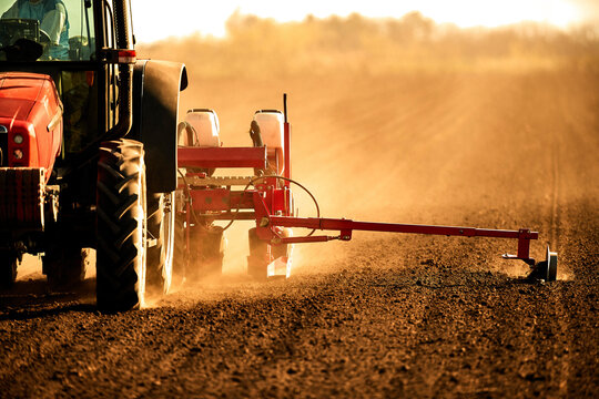 Tractor seeding soybean at arable field