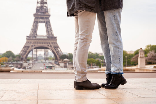 Couple standing in front of Eiffel Tower, Paris, France