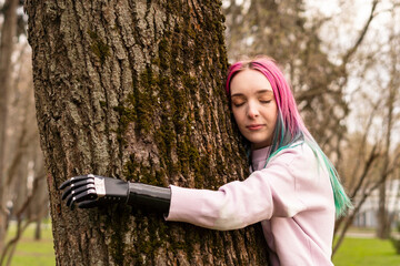 Woman with amputated hand embracing tree trunk