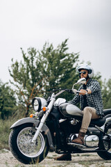 Fototapeta na wymiar Handsome man with his moto in sand quarry