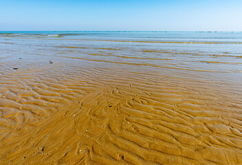 View of the Adriatic Sea from the sandy beach in Pesaro, Italy, during a sunny spring day