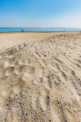 View of the Adriatic Sea from the sandy beach in Pesaro, Italy, during a sunny spring day