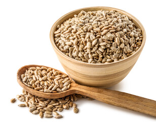 Wooden spoon and bowl with peeled sunflower seeds on white background, closeup
