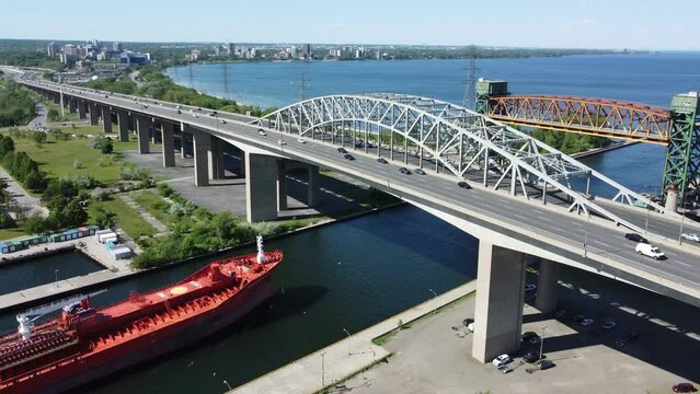 Large boat passing over busy highway towards elevated bridge - Ontario, Burlington.