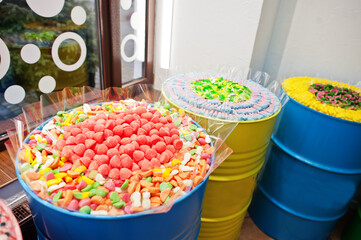 Barrels with sweets in candy shop.