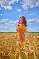 Naklejka premium A happy caucasian young and beautiful woman in a field.