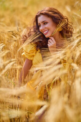 A happy caucasian young and beautiful woman in a field.