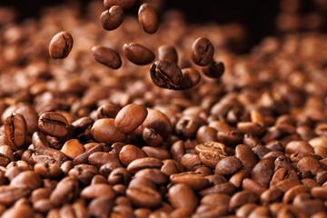 Background with falling coffee beans. Selective focus.