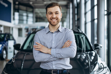 Business man choosing a car in car salon