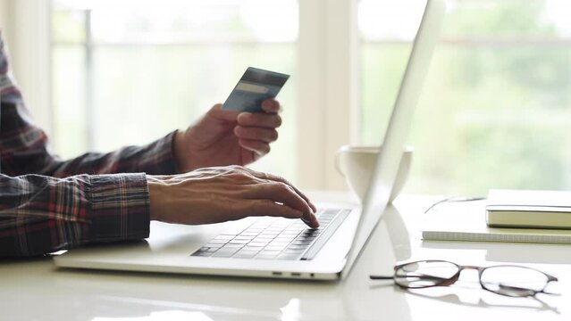 Woman using laptop computer with credit card making online payment. Business, online shopping, e-commerce, internet banking, spending money, working from home concept
