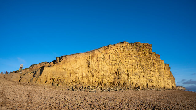 UK, England, West Bay, Sandy beach and sandstone cliffalong Jurassic Coast
