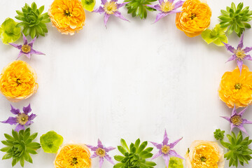 Composition of beautiful flowers, succulents and leaves on light background. Flowers frame.Top view, copy space.