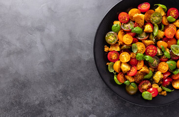 Cherry Tomatoes salad and bread. Traditional italian salad Panzanella. Healthy Mediterranean cuisine.Top view