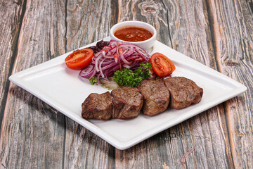 Tasty beef tenderloin kebab with sauce