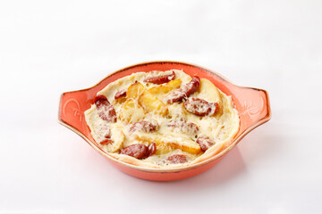 Potatoes with salami and cheese on a white background