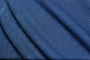 blue fabric with folds close-up, texture, background