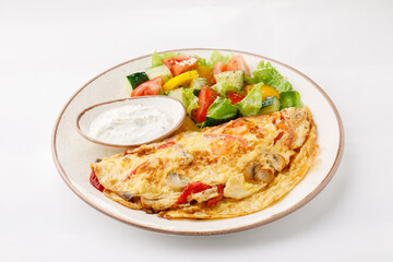 Omelette with ham and salad on a white background