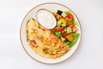 Omelette with ham and salad on a white background