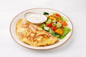 Omelette with ham and salad on a white background