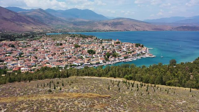 Aerial drone video from picturesque and traditional historic village of Galaxidi featuring landmark church of Agios Nikolaos, Fokida, Greece
