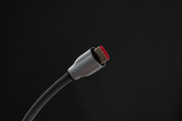 A close up image of hdmi cable on the black background
