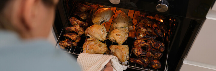 The woman determines the readiness of the chicken in the oven