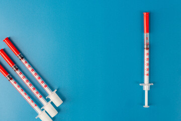 Medical syringes for insulin on a blue background. Diabetes