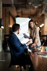 Businesswoman present her idea to working team. Young beautiful woman presenting businessplan