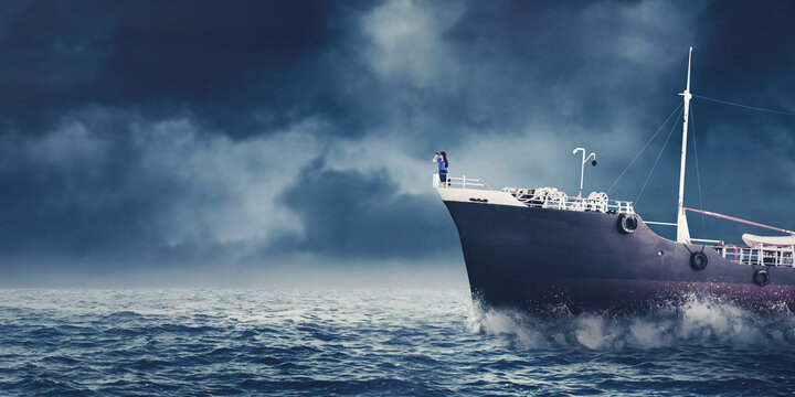 Young businesswoman using binoculars on the ship