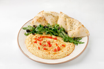 Hummus with pita and salad on a white background