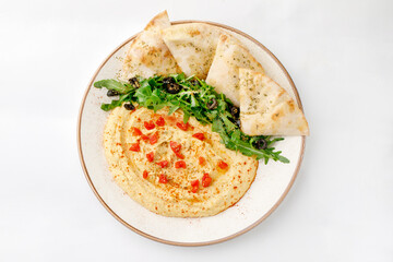 Hummus with pita and salad on a white background