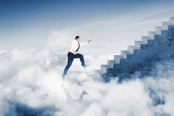 Fototapeta na wymiar Businessman running on the stairs above the clouds