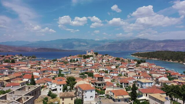 Aerial drone video from picturesque and traditional historic village of Galaxidi featuring landmark church of Agios Nikolaos, Fokida, Greece