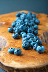 Ripe blueberries closeup on a wooden background. Vertical composition.