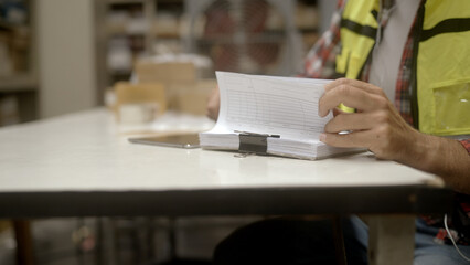 Fototapeta na wymiar Employee is checking the goods in the warehouse.