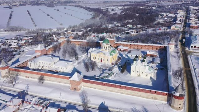 View from drone of snow covered architectural ensemble of Zaraysk Kremlin with Forerunner and St. Nicholas cathedrals on winter day, Russia