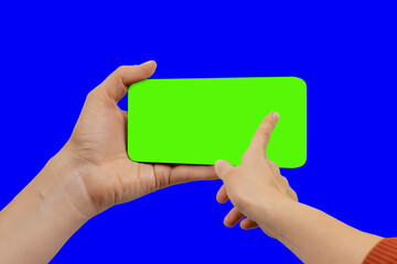 Young woman swiping up on green chroma key smartphone display, the device is positioned slightly turned