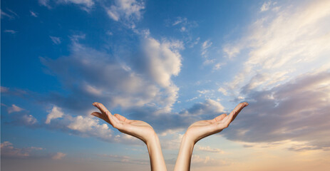 Hands on blue sky clouds background. Power of hope or love and devotion